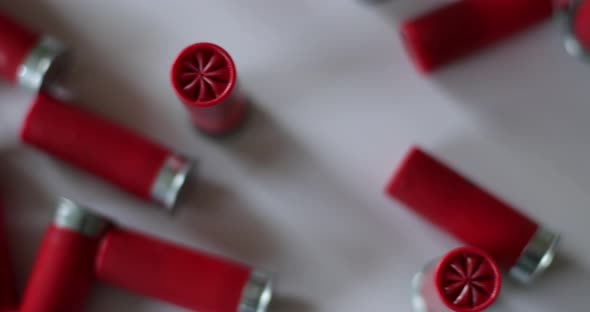 Shotgun shells scattered on white surface