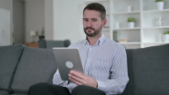 Professional Young Man Using Tablet in Office