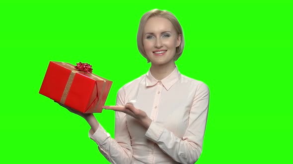 Woman Pointing at Red Gift Box