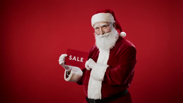 Portrait of Santa Claus Holding Lettering in Hands