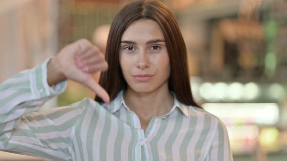 Disappointed Young Latin Woman Doing Thumbs Down 