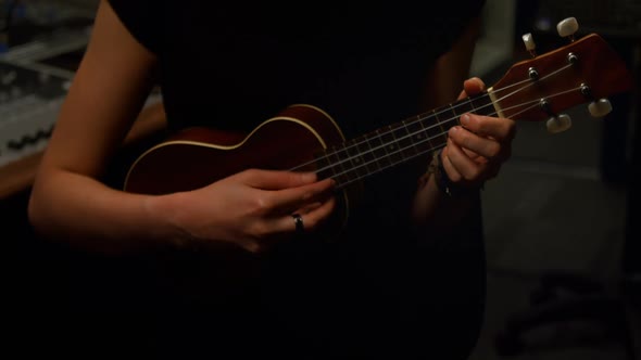 Woman playing a guitar