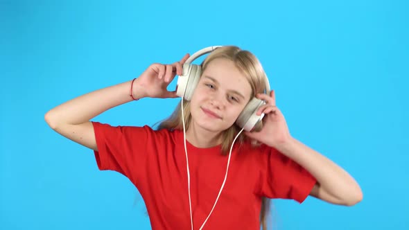 Girl Listening To Music in Big White Headphones, Singing and Dancing