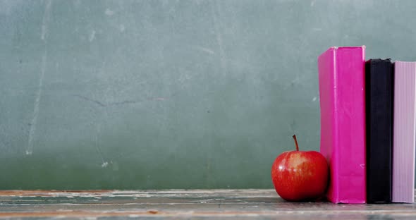 Apple and book on table