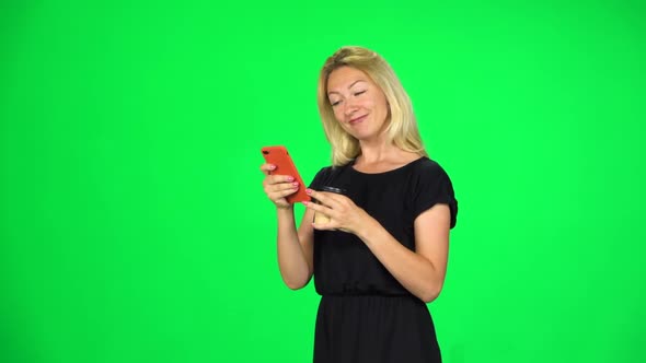 Blonde Girl Goes and Texting with Smartphone While Holding a Paper Cup of Coffee, Chroma Key, Slow