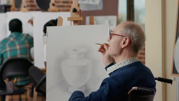 Senior Student with Disability Using Pencil to Draw Vase Model