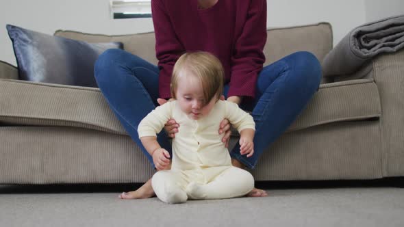 Close up of caucasian baby crawling on the floor at home