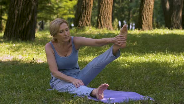 Adult Gracefully Demonstrating Yoga Poses in Park, Amateur Workout, Fitness