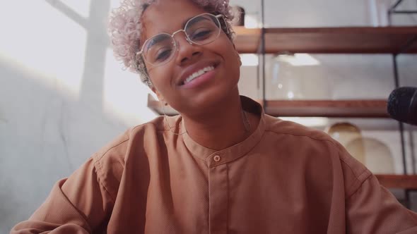 Female Blogger Waving Her Hand in Front of the Camera While Recording a Video