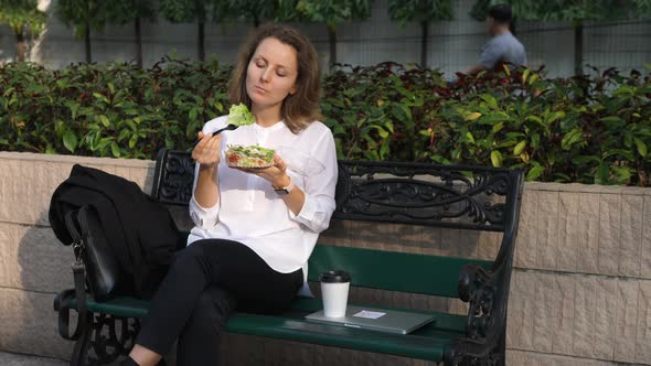 Happy Young Business Woman Eating A Healthy Salad On Lunch Break