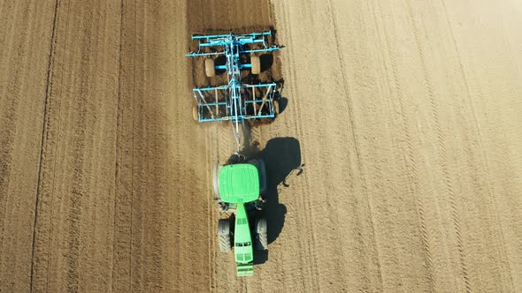 Tractor with Disc Harrows on the Farmland