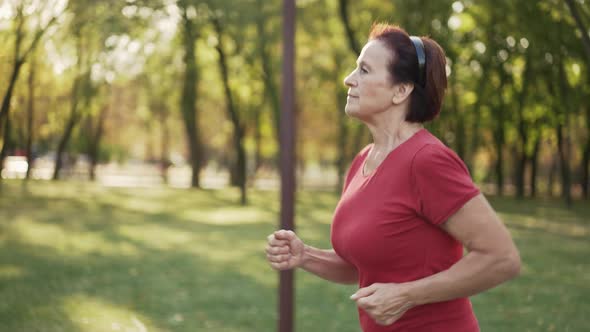 Elderly Woman Runs at the Park