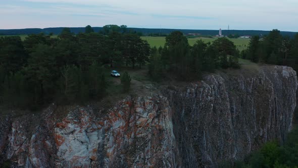 Aerial View of a Car on the Edge of a Cliff