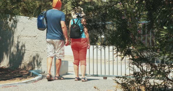 Couple with Backpacks Going for Walk