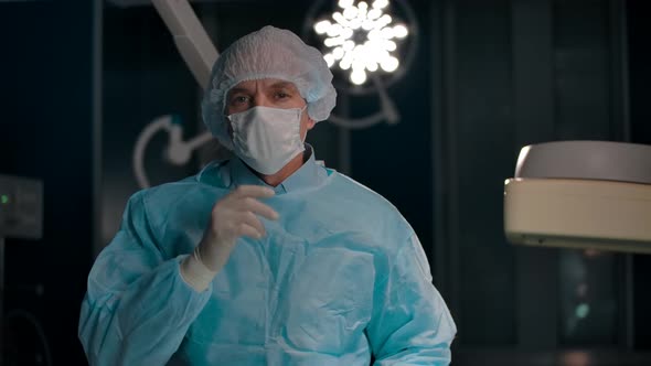 Portrait of a Surgeon Removing a Mask After a Successful Operation