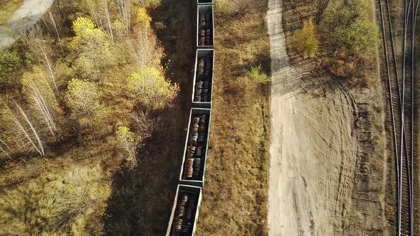 Aerial View of Freight Wagons in Countryside. Bird's Eye View of Railroad Station with Freight Train