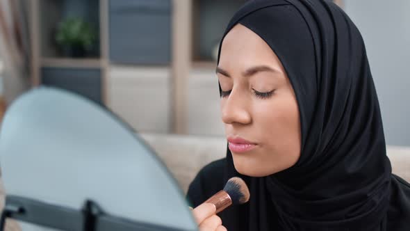 Closeup Ethnic Arabic Woman in Hijab Applying Cosmetics on Face Looking at Mirror Makeup Themselves