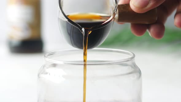 Soy Sauce Pouring From a Spoon