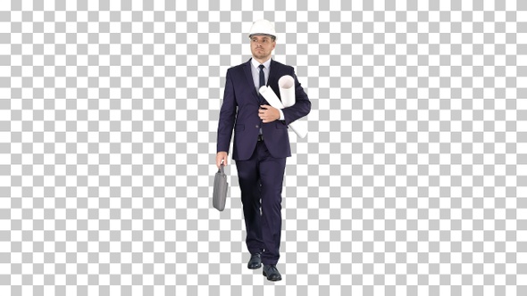 Male architect in a suit and hard hat walking with blueprints