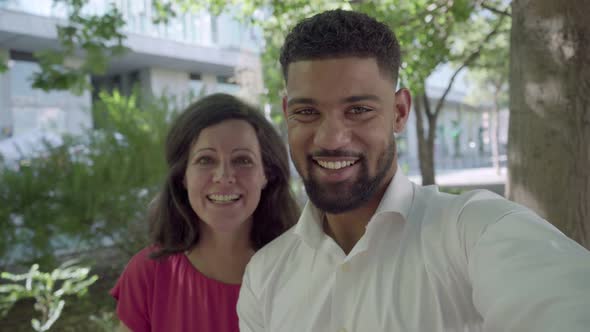 Cheerful Couple Looking at Camera and Laughing