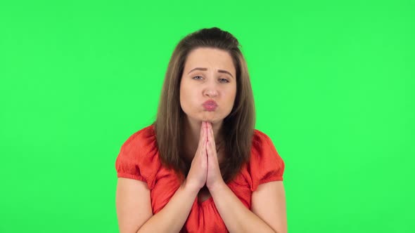 Portrait of Cute Girl Keeping Palm Together and Asking for Something . Green Screen