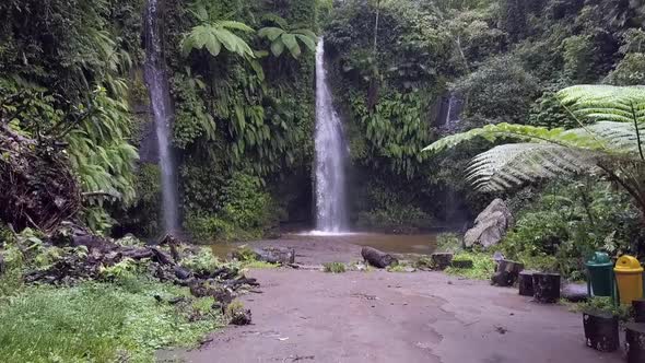 Slow motion jurassic park jungle.Beautiful aerial view flight pull in drone footage.Waterfall Bena