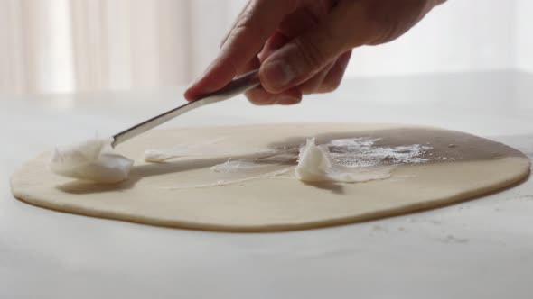 Professional puff pastry  making with fat spreading over dough with knife   4K 2160p UltraHD footage