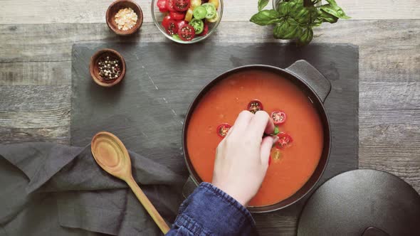 Roasted tomato soup in cast iron cooking pot.