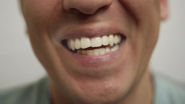 Young man laughing happily right into the cameras, close up