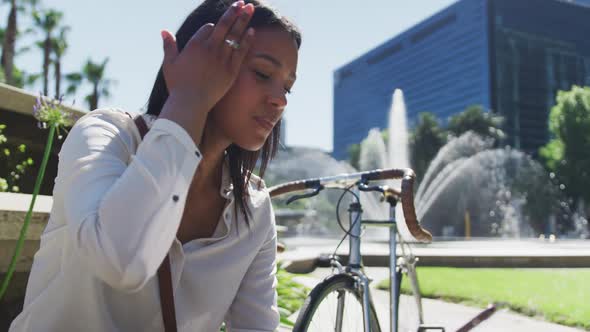 African american woman using smartphone in city park