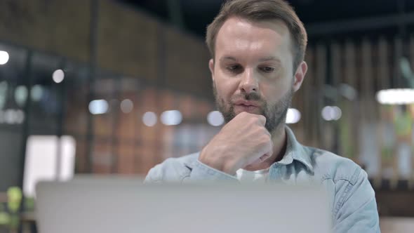 Thoughtful Young Man Thinking at Work