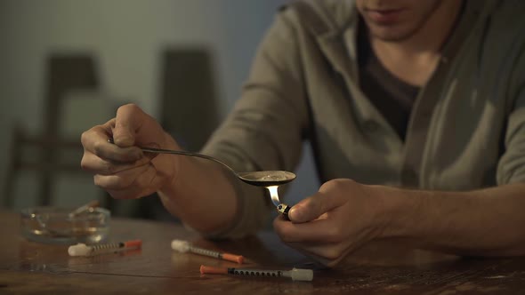 Man Sitting at Derelict Room, Preparing Drug Dose for Injection, Video Sequence