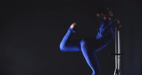 Young Woman Wearing Blue Costume is Doing Gymnastics in a Hoop Show