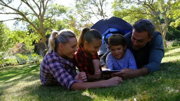 Family taking a selfie outside the tent