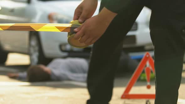 Policeman Unrolling Caution Tape at Traffic Accident Scene, Warning Sign, Crime