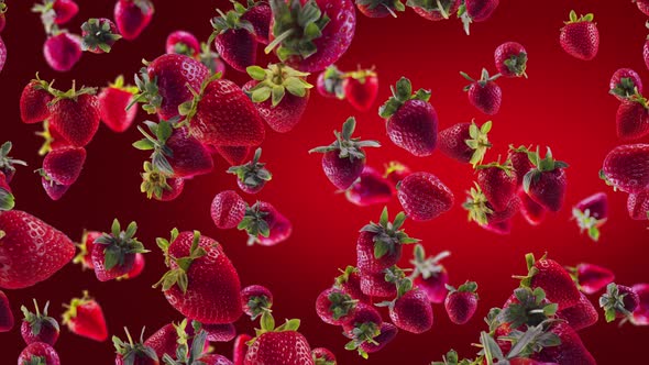 Strawberry with Slices Falling on Deep Red Background