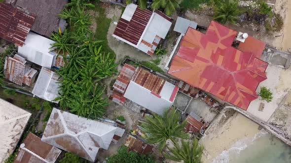 Beautiful bird's eye view flying over the houses along the shore of the small rural town of Matutina