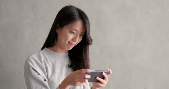 Woman use of smart phone over grey background