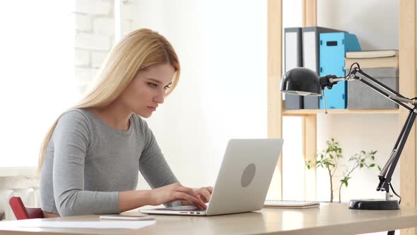 Frustrated Young Woman Working on Laptop