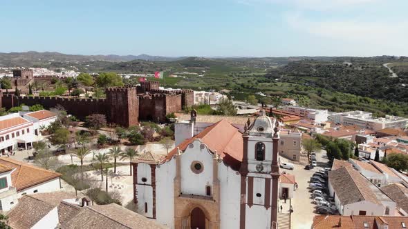 Pull-away, 4k drone footage revealing surrounding area around the historical Silves Cathedral