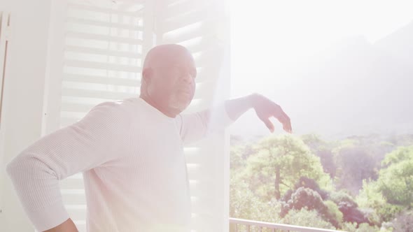 Thoughtful african american senior man looking outside window