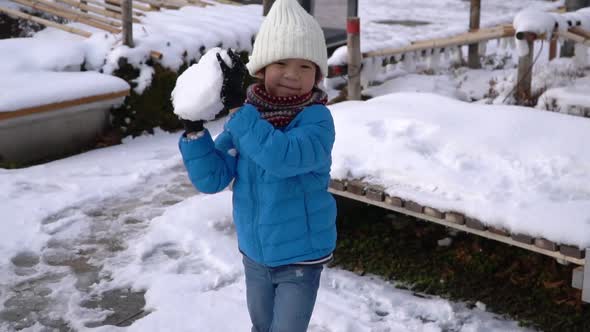 Cute Asian Child Playing Snow In The Park