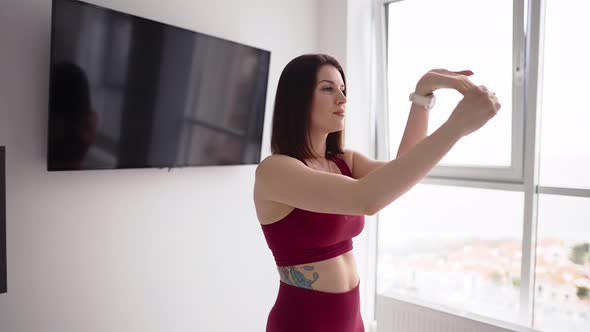 Brunette Woman Exercising at Home Bending Fists
