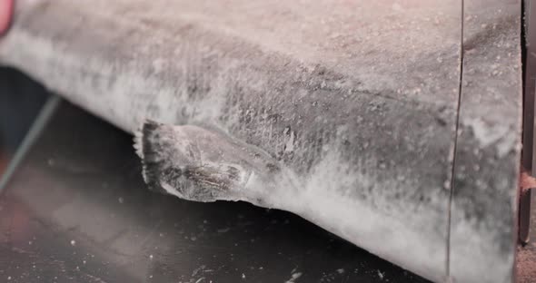 Vendor Cuts The Frozen Salmon Into Salmon Steak Cut. close up