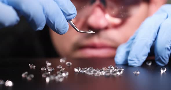 Jeweler Holding Diamond in His Hands and Checking Its Authenticity  Movie Slow Motion