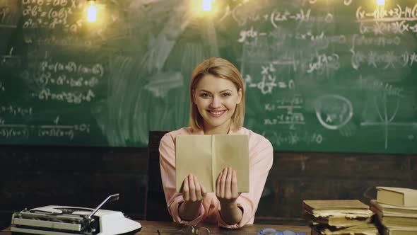 Smiling Happy Female College Student Sitting in Classroom