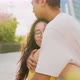 Asiatic young couple outdoor hugging in love with affection and protection smiling serene - VideoHive Item for Sale