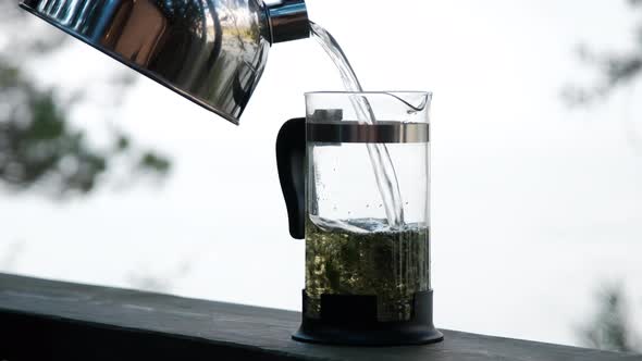 Close-up of Man Brewing Herbal Tea in Nature