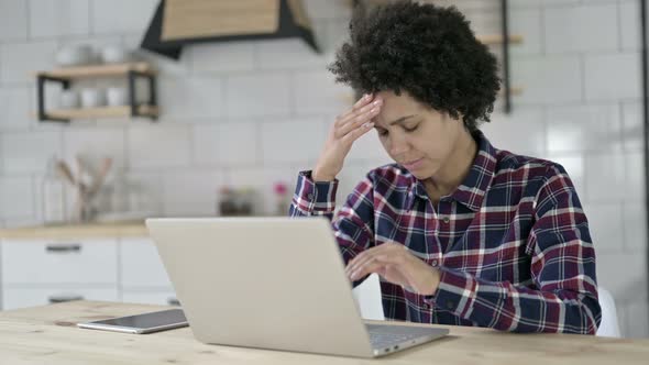 African American Woman Having Headache in Office