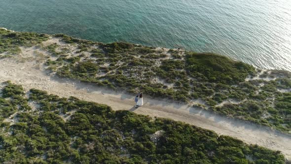 Couple Dancing On Road With Sea Aerial View